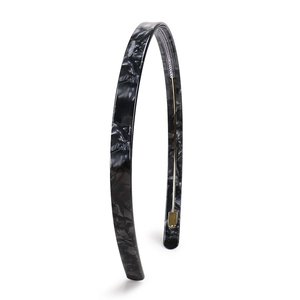 Detail of marble pattern acetate headband with inner gold metal frame and anti-slip buckle