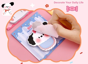 Close-up showing the peel-off action of cute cartoon puppy shaped sticky notes