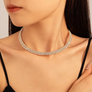 Macro detail of luxury double-row rhinestone geometric choker with sparkling gold finish
