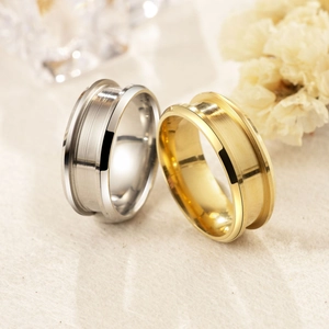 Detailed view of 8mm gold and silver stainless steel rings with brushed finish texture
