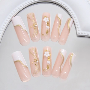 French tip press-on nails with 3D white daisies and gold bead accents in long coffin shape