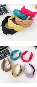 Detail of wide knotted headbands in multiple solid colors with a textured fabric finish