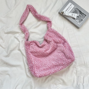Close-up of pink leopard print plush fabric texture and soft wide shoulder strap