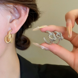Golden and silver knot twisted C-shaped earrings with minimalist geometric design