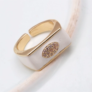 Detail view of gold-plated evil eye ring with white enamel and champagne zircon stone