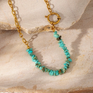 Detailed close-up of Bohemian turquoise stone chips on a golden stainless steel chain