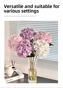 Close-up of 3D hydrangea floral arrangement in a glass vase with soft natural window light