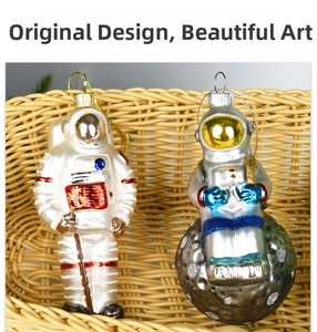 Detail of glass astronaut Christmas ornaments with shiny metallic finish and hanging loops