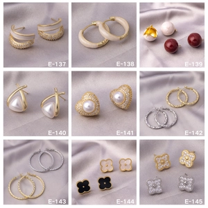 Grid display of nine luxury earring styles including studs and hoops in gold and silver