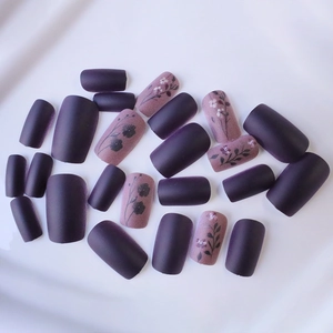 Matte press-on nails in deep purple and grey-pink with vintage flower and leaf designs