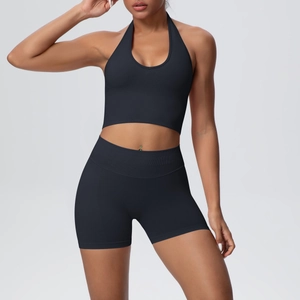 Close-up of black seamless ribbed knit fabric on halter sports top and high waist shorts set