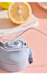 Detail of blue lid cleaning with narrow metal brush for stainless steel bottles