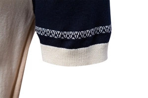 Close-up of navy and cream knitted polo shirt sleeve with ribbed cuffs and stitching