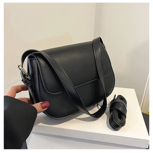 Detail view of smooth black leather crossbody bag with detachable matching shoulder strap
