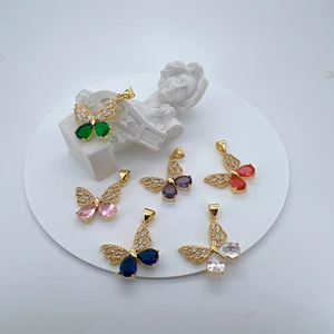 Macro shot of 6 gold plated butterfly pendants with colorful micro inlaid cubic zirconia