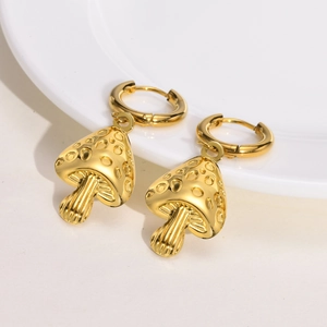 Detailed close-up of golden mushroom earrings with realistic textured grooves