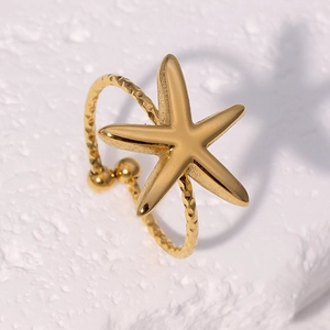 Minimalist 18k gold starfish open ring with hammer texture on natural stone background