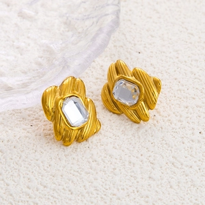 Elegant 18K gold plated bow earrings with rectangle zircon crystals on a white stone background