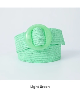 Close-up of light green woven stretch belt with round resin buckle and straw texture