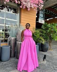 Detail of rose pink halter neck maxi dress with large skirt and cinched waistline