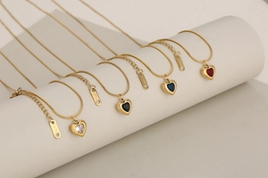Detail of stainless steel snake chain necklaces with crystal heart pendants in four colors