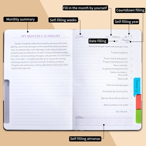 Undated daily planner notebook with monthly summaries and colorful index tabs