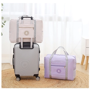 Detail of travel duffel bag with luggage sleeve attachment on suitcase handle