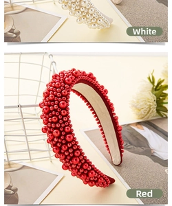 Detail view of full pearl headbands in white and red colors with vintage luxury style