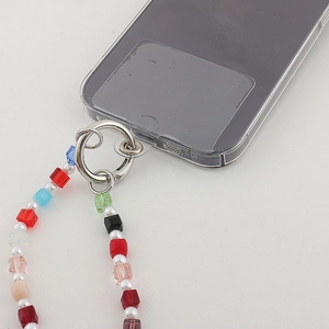 Close-up of colorful crystal star phone strap with pearl beads and silver metal ring
