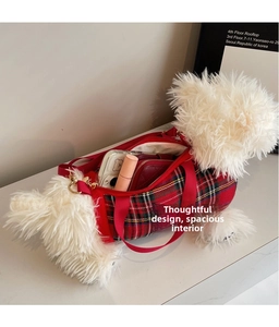 Detail view of the puppy plush bag showing interior space with phone and wallet