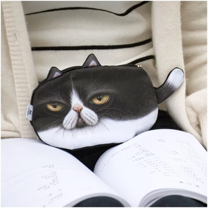 Detail of plush cat coin purse with realistic black and white feline print and ears