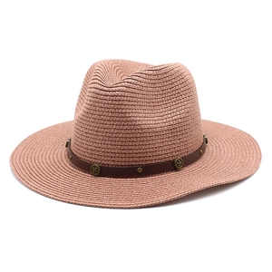 Pink straw fedora beach hat with flat brim and decorative brown leather band