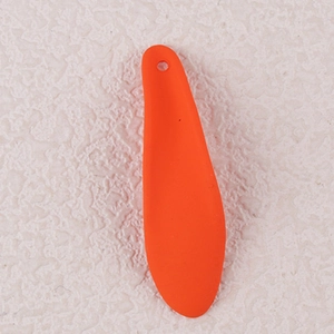 Detail view of orange acrylic petal pendant with hole on pink textured background