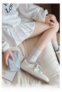 Detailed texture of white and grey ribbed knit cotton socks with soft elastic cuffs