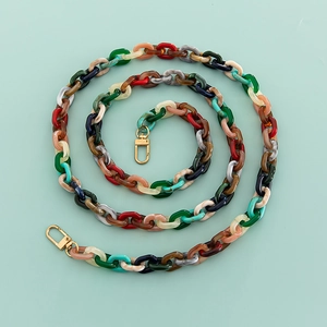Detail of colorful marble pattern acrylic chain with golden metal spring clasps for bags