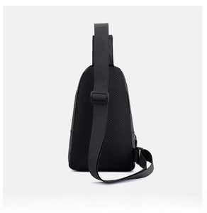 Detail of the breathable honeycomb mesh back and adjustable strap on the black chest bag