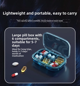 Close-up of a blue 6-compartment portable pill box showing 5-7 days of medication storage