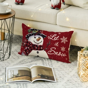 Christmas snowman linen pillow cover with Let it Snow print in cozy holiday setting