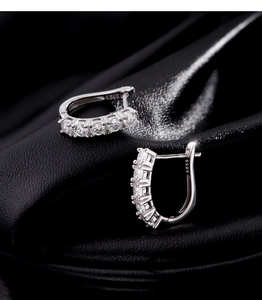 Detailed shot of S925 silver U-shaped hoop earrings with sparkling moissanite stones