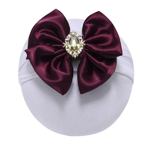 Elastic baby nylon headband featuring a large burgundy satin bow with a crystal center