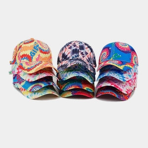 Detailed view of colorful tie-dye baseball caps stacked in multiple vibrant color patterns