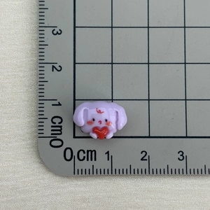 Detailed close-up showing small purple resin bunny charm with scale measurement for size