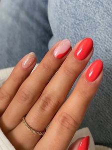 Close-up of luxury long glitter press-on nails with shiny rhinestones and red finish