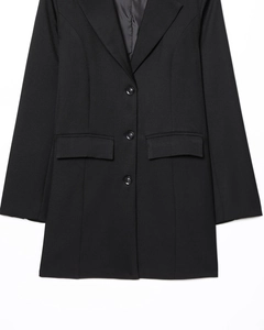 Detail of black long-sleeved blazer with classic notch lapels and three-button closure