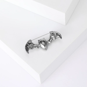 Silver bat shaped alloy rhinestone brooch for men shown on minimalist white background