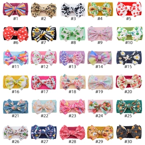Collection of 30 colorful baby nylon headbands with large bows in various vibrant patterns