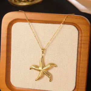 Macro shot of a golden starfish pendant necklace with fine texture on a wooden display