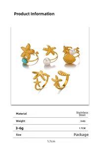 Detail of five-piece gold stainless steel ocean ring set with starfish and pearls