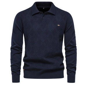 Macro shot of navy blue knit polo shirt featuring textured diamond pattern and lapel collar