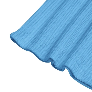 Macro shot of blue waffle knit fabric detail showing breathable texture on polo shirt